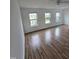 This bedroom has wood floors and multiple windows that let in an abundance of light at 2511 Dalmahoy Ln, Fuquay Varina, NC 27526