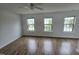 This bright bedroom offers wood floors and many windows with natural light at 2511 Dalmahoy Ln, Fuquay Varina, NC 27526