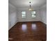 Formal dining room featuring wainscoting, hardwood floors, and an ornate chandelier at 2511 Dalmahoy Ln, Fuquay Varina, NC 27526