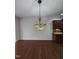 Dining room with decorative chandelier and hardwood floors, adjacent to kitchen at 2511 Dalmahoy Ln, Fuquay Varina, NC 27526