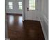 Elegant entryway featuring hardwood floors, white trim, and a decorative front door with sidelights at 2511 Dalmahoy Ln, Fuquay Varina, NC 27526
