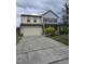 Inviting two-story home with a spacious driveway and well-maintained front yard at 2511 Dalmahoy Ln, Fuquay Varina, NC 27526