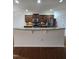 Open kitchen with granite countertops, stainless appliances, dark cabinets, and breakfast bar at 2511 Dalmahoy Ln, Fuquay Varina, NC 27526