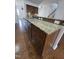 Close up of kitchen island with granite countertops, dark wood cabinetry, and stainless steel dishwasher at 2511 Dalmahoy Ln, Fuquay Varina, NC 27526