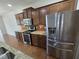 Modern kitchen featuring stainless steel appliances and dark wood cabinetry with granite countertops at 2511 Dalmahoy Ln, Fuquay Varina, NC 27526