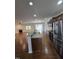 Open concept kitchen with stainless steel appliances, granite countertops, and hardwood floors at 2511 Dalmahoy Ln, Fuquay Varina, NC 27526