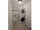 A laundry room with stacked washer and dryer, complete with shelving for added convenience at 2511 Dalmahoy Ln, Fuquay Varina, NC 27526