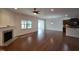 Bright living room with hardwood floors, fireplace, and views into the kitchen and outdoor space at 2511 Dalmahoy Ln, Fuquay Varina, NC 27526