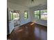 Bright living room with hardwood floors, large windows, and access to the backyard patio at 2511 Dalmahoy Ln, Fuquay Varina, NC 27526