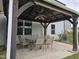 View of a covered patio with a table and chairs, and the exterior of a home at 2511 Dalmahoy Ln, Fuquay Varina, NC 27526