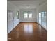 Bright sunroom with hardwood floors, white walls, and multiple windows for ample natural light at 2511 Dalmahoy Ln, Fuquay Varina, NC 27526