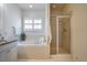 Bright bathroom with soaking tub and a glass enclosed shower at 253 Tobacco Farm Way, Chapel Hill, NC 27516