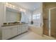 Bright bathroom with a soaking tub, walk-in shower, and dual sink vanity at 253 Tobacco Farm Way, Chapel Hill, NC 27516