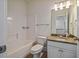 Well-lit bathroom featuring a vanity with granite countertop, a bath, and a toilet at 253 Tobacco Farm Way, Chapel Hill, NC 27516