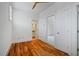 Bedroom with hardwood floors, white walls, and an ensuite bathroom with natural light at 253 Tobacco Farm Way, Chapel Hill, NC 27516