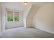 Finished attic bedroom with neutral carpet, recessed lighting, and windows with light-blocking blinds at 253 Tobacco Farm Way, Chapel Hill, NC 27516