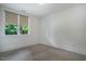 Clean bedroom space with a patterned carpet and a window with a view of lush trees at 253 Tobacco Farm Way, Chapel Hill, NC 27516
