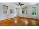 Bright bedroom with hardwood floors and multiple windows offering ample natural light at 253 Tobacco Farm Way, Chapel Hill, NC 27516