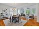 Open dining room and living room with hardwood floors and large windows and modern lighting at 253 Tobacco Farm Way, Chapel Hill, NC 27516