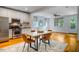 This modern dining room features stainless steel appliances and stylish hardwood floors at 253 Tobacco Farm Way, Chapel Hill, NC 27516
