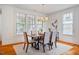 Light-filled dining room featuring modern chandelier and hardwood floors at 253 Tobacco Farm Way, Chapel Hill, NC 27516