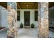 A front entrance with stone pillars and a concrete walkway welcomes guests to the home at 253 Tobacco Farm Way, Chapel Hill, NC 27516