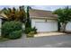 The garage is white with a paved driveway and lots of greenery in the yard at 253 Tobacco Farm Way, Chapel Hill, NC 27516