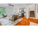 Open-concept living space with hardwood floors, kitchen, and staircase and large windows at 253 Tobacco Farm Way, Chapel Hill, NC 27516