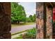 A charming residential street view framed by the stone columns of a front porch at 253 Tobacco Farm Way, Chapel Hill, NC 27516