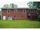 Backyard with a brick house, window and green grass at 2626 Crestline Ave, Raleigh, NC 27603