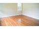 Bright, airy bedroom with hardwood floors and large windows, providing ample natural light and a serene feel at 2626 Crestline Ave, Raleigh, NC 27603