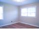 Bedroom with lots of light coming through the windows with hardwood floors and trim at 2626 Crestline Ave, Raleigh, NC 27603