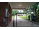 View of a car port on a brick house with a driveway surrounded by mature trees at 2626 Crestline Ave, Raleigh, NC 27603