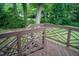 Wooden deck with crossbeam railing surrounded by trees at 2626 Crestline Ave, Raleigh, NC 27603