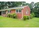 Charming brick ranch-style home featuring a well-maintained lawn and mature trees, offering a serene setting at 2626 Crestline Ave, Raleigh, NC 27603