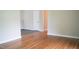 Hardwood floors lead to a doorway, offering a peek into the next room, showcasing the home's layout and design at 2626 Crestline Ave, Raleigh, NC 27603