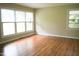 Bright living room featuring gleaming hardwood floors and large windows offering plenty of natural light at 2626 Crestline Ave, Raleigh, NC 27603