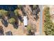 Bird's eye view of a house and surrounding property featuring a pond, road, and plenty of foliage at 2630 Ponderosa Rd, Cameron, NC 28326