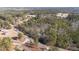 Aerial view of wooded acreage with road access and neighborhood, highlighting the property's location at 2630 Ponderosa Rd, Cameron, NC 28326