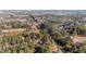This aerial view showcases a peaceful neighborhood surrounded by lush trees and multiple properties at 2630 Ponderosa Rd, Cameron, NC 28326