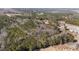 The aerial view shows a vast, densely wooded area with some properties in the distance, showcasing its tranquil location at 2630 Ponderosa Rd, Cameron, NC 28326