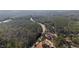 The aerial view showcases a road cutting through a dense forest, highlighting the serene natural setting at 2630 Ponderosa Rd, Cameron, NC 28326
