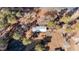 Scenic aerial perspective of the property with a private pond and plenty of mature trees at 2630 Ponderosa Rd, Cameron, NC 28326