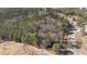 A high, aerial view of partially wooded acreage, a road and what looks like a fence line at 2630 Ponderosa Rd, Cameron, NC 28326
