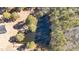 Aerial view of a serene pond surrounded by lush greenery and mature trees, adding natural beauty at 2630 Ponderosa Rd, Cameron, NC 28326
