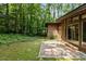 View of house highlighting brick patio and wooded backyard area at 2706 Montgomery St, Durham, NC 27705