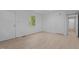 Bright bedroom features wood-look flooring, a window, and a closet for ample storage at 2706 Montgomery St, Durham, NC 27705