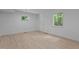 Bright bedroom showcasing wood-look floors and two windows offering natural light at 2706 Montgomery St, Durham, NC 27705