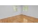 Bright bedroom featuring hardwood floors and two windows providing ample natural light at 2706 Montgomery St, Durham, NC 27705