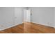 Bright bedroom featuring hardwood floors and multiple doors to adjacent rooms at 2706 Montgomery St, Durham, NC 27705